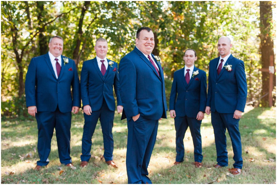 groom in front of groomsmen outside