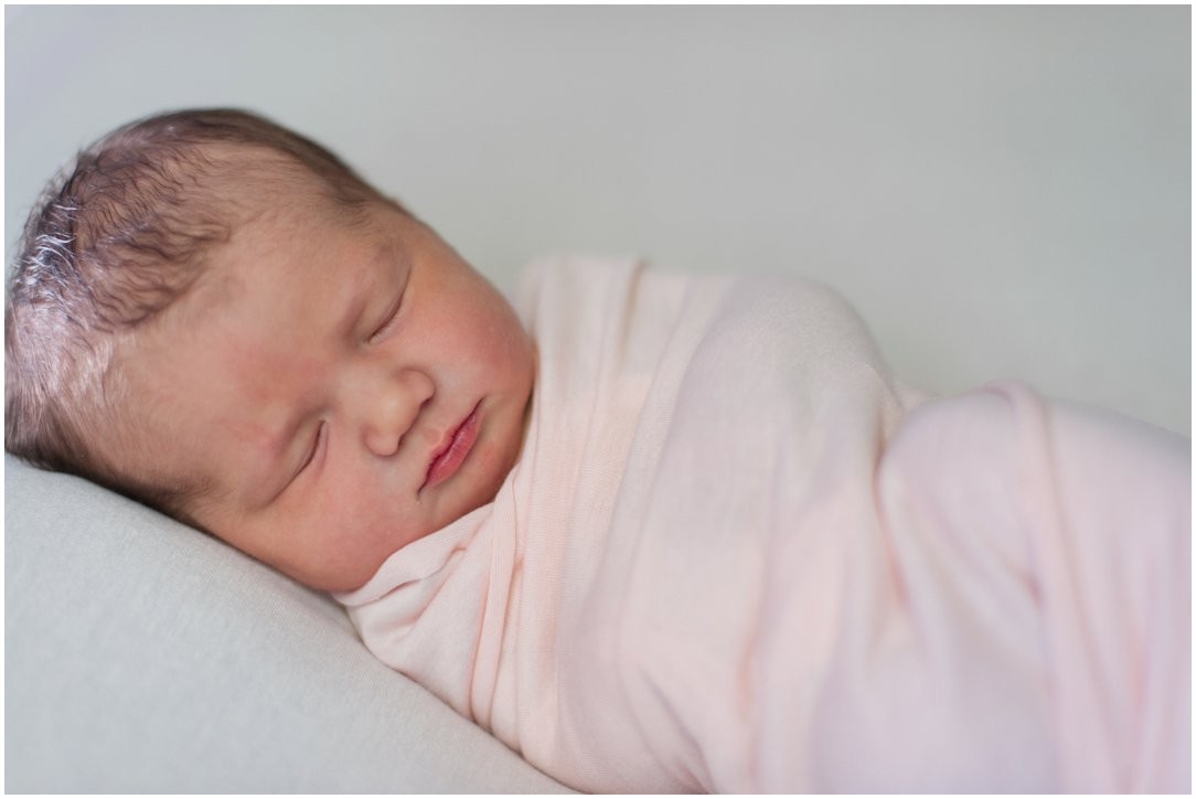 newborn swaddled in pink